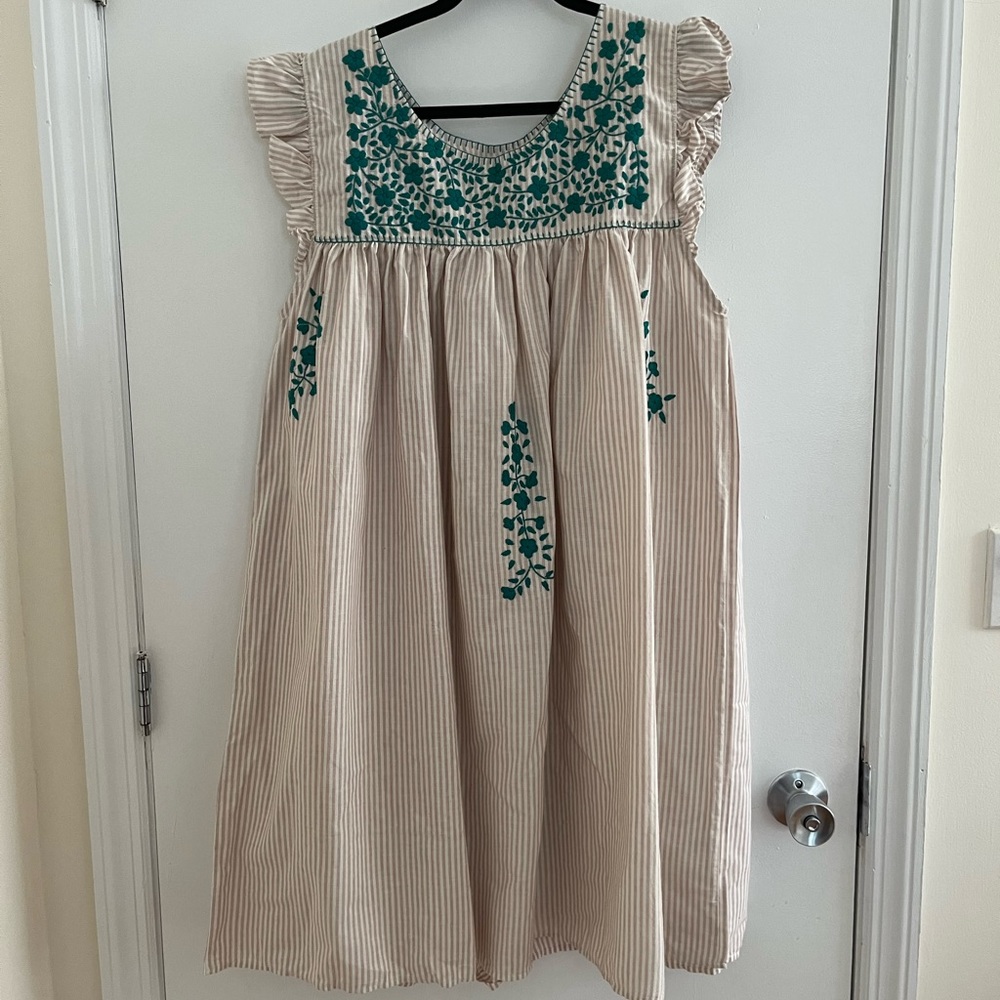 Tan and cream stripes with teal embroidery. Never worn.